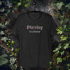Gothic-style text design reading “Plotting in Silence” in bold, moody font on a black t-shirt.