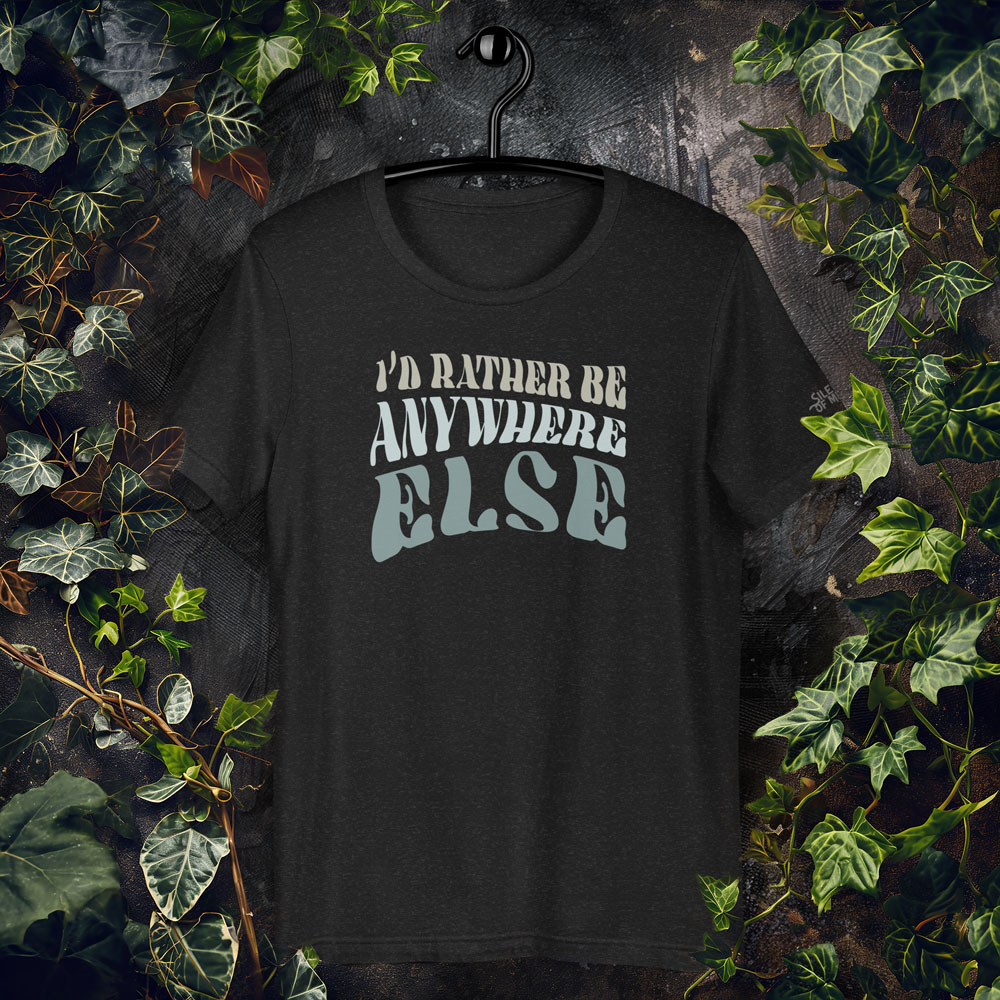 Text-based graphic t-shirt reading “I’d Rather Be Anywhere Else” in layered vintage-style fonts on black background.