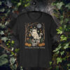 Linocut-style Ghost Cat T-shirt design featuring a spectral cat with lantern, skull with mushrooms, pumpkins, eerie trees, and glowing will-o’-the-wisps under a secretive moon.