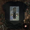 The Star Tarot Cat T-shirt design featuring a mystical black cat with a star on its forehead, subtle lilac flowers, and celestial symbols, perfect for fans of tarot and quiet cosmic wisdom.