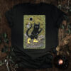 The Fool Tarot Cat T-Shirt featuring a black cat stepping forward, symbolizing trust, beginnings, and movement into the unknown.