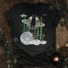 Horsetail cat t-shirt featuring a contemplative cat seated on Saturn above the Moon with horsetail, mushrooms, and symbolic botanical elements.